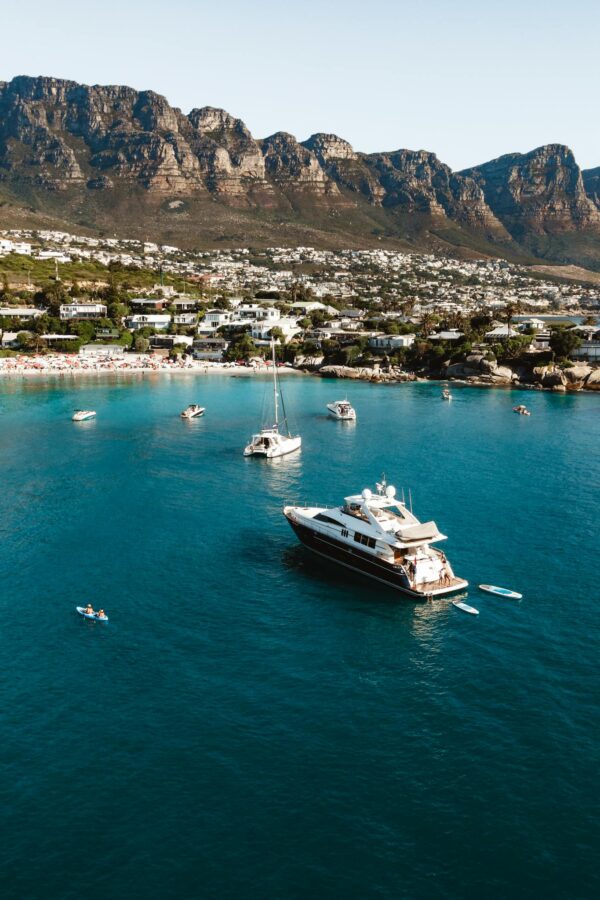 A boat is docked in the water near a mountain
